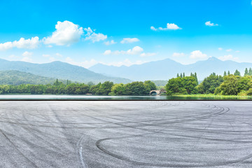 Asphalt road pavement and green mountain