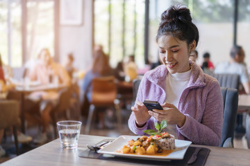 woman using smartphone in restaurant