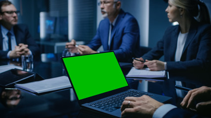 Poster - On the Table Laptop Showing Green Mock-up Screen: Team of Politicians, Corporate Business Leaders and Lawyers Sitting at the Negotiations Table in the Conference Room, Trying to Come to an Agreement. 