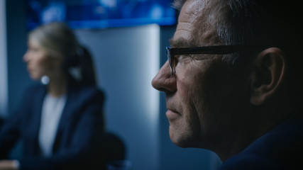 Wall Mural - Portrait of the Senior Member of the Board Of the Directors Listening to His Business Partners on a Meeting.