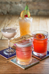 Wall Mural - different colorful alcohol and non-alcohol cocktails in the glasses on the table