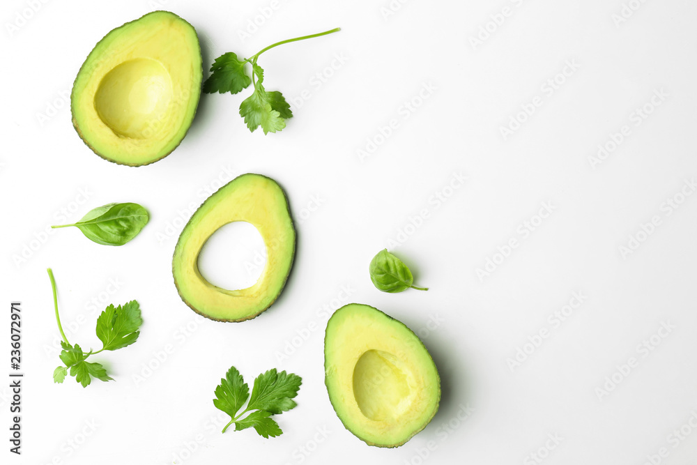 Composition with cut avocado on white background
