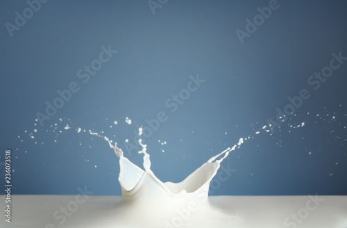 Fotografía Splash of milk on color background