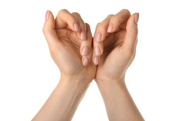 Female hands with nude manicure on white background