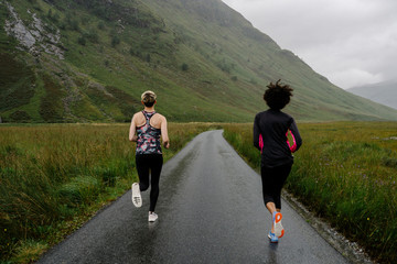 Wall Mural - Friends jogging in the Scottish Highlands