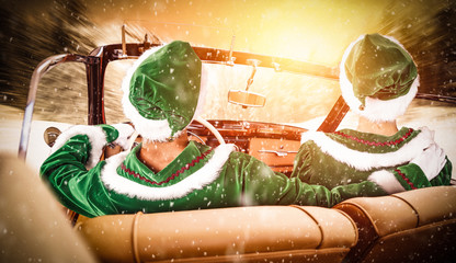 Wall Mural - Christmas time and two elfs in car on winter road 