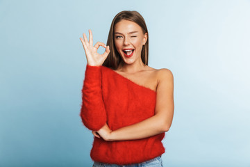 Wall Mural - Lovely young woman wearing sweater standing