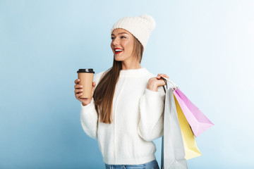 Wall Mural - Happy young woman wearing sweater standing