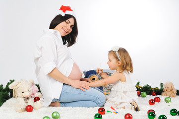 Wall Mural - Smiling Girl and Pregnant Mother with Christms Balls