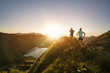 © Westend61 - Man and woman running on mountain trail during sunrise