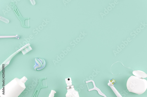 Cuadros en Lienzo Flat lay composition with manual toothbrushes and oral hygiene products on mint background Stomatologist mock up copy space