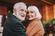 © Yakobchuk Olena - Portrait of joyful bearded man and his wife turning back and smiling. Focus on man