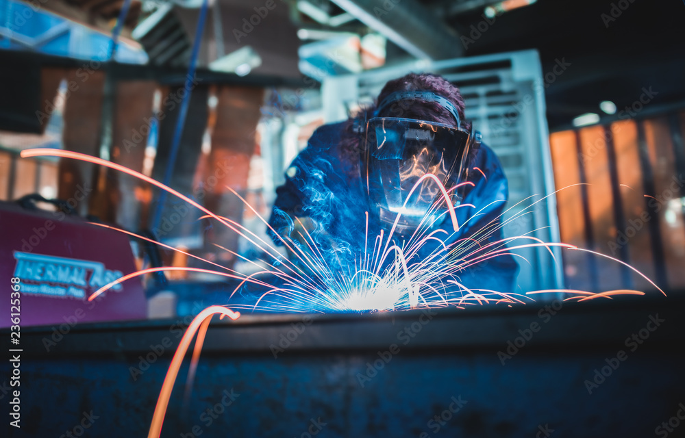Skilled welder in industrial workshop