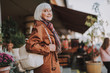 © Yakobchuk Olena - Time for a walk. Waist up portrait of old woman in coat looking at camera and smiling