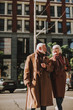 © Yakobchuk Olena - Portrait of stylish gentleman with cane enjoying company of his wife on sunny day. They looking at each other and smiling