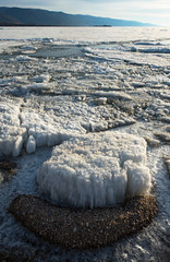 The white ice floes on the blue water of the lake. Lake Baikal in spring.