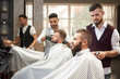 © serhiibobyk - View from side of process of styling hair in barbershop