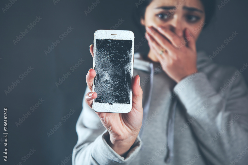 sad woman hand broken phone - obrazy, fototapety, plakaty 