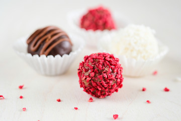 Wall Mural - Red truffles with dried strawberry and one chocolate truffle