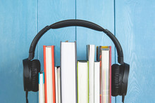 Headphone And Books On Blue Background