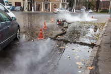 Odessa, Ukraine- Nov. 28, 2018: Accident On Heating Main. Burst Pipes With Hot Water. Winter Cold Heating Pipes Could Not Withstand Frost And Burst. Steam From Hot Water. Emergency Rescuers With Pump
