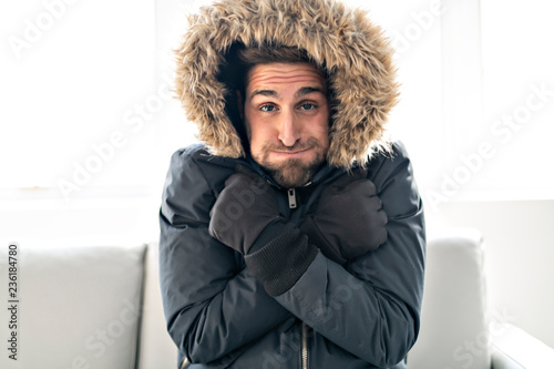 Cuadros en Lienzo A Man have cold on the sofa at home with winter coat