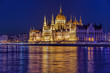 Parliament building of Budapest above Danube river in Hungary at night.