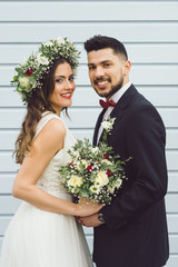 young couple bride groom getting married wedding posed photos at seaside sea beach hairpiece flowers bouquet church