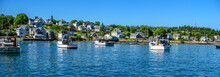 Maine Lobster Boats Anchored In A Bay In Front Of A Quaint New England Village