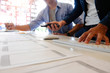 © Prathankarnpap - Team software development working with pre-project design application on mobile with paper.