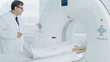 © Gorodenkoff - In Medical Laboratory Radiologist Controls MRI or CT or PET Scan with Female Patient Undergoing Procedure. High-Tech Modern Medical Equipment. Friendly Doctor Chats with Patient.