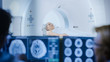© Gorodenkoff - In Medical Laboratory Patient Undergoes MRI or CT Scan Process under Supervision of Doctor and Radiologist in Control Room, They Watche Procedure and Monitors Brain Activity Results.