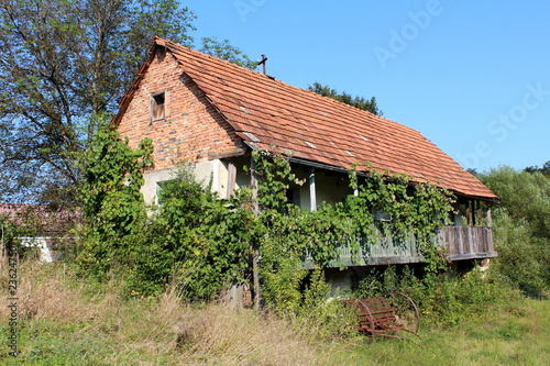 Old Abandoned Red Brick Family House With Wooden Porch And