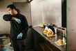 © FOLIO - Chef preparing burgers in his food truck