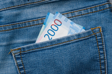 Jeans pocket with banknotes of two thousand Russian rubles