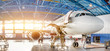 Maintenance and repair of aircraft in the aviation hangar of the airport, view of a wide panorama.