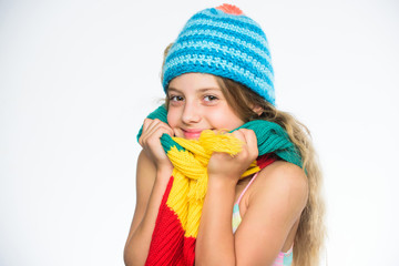 Kid wear warm soft knitted blue hat and long scarf. Warm woolen accessories. Hat and scarf keep warm. Which fabrics will keep you warmest this winter. Girl long hair happy face white background