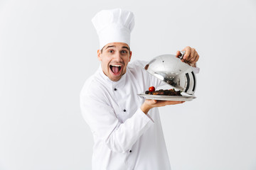 Wall Mural - Excited man chef cook wearing uniform