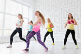 Group of happy young women having a fitness dance class
