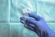 The doctor's hand in a blue glove while preparing a smear of liquid for smears using a centrifuge for examining a woman. A sample of non-singular cytology and pathology. The concept of treatment.