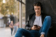 © Goran - Relaxed young man listening music over headphones