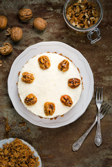 Wall Mural - Carrot and walnut cake with cream cheese frosting. Top view.