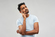 © Syda Productions - doubts and people concept - indian man thinking and looking up over grey background