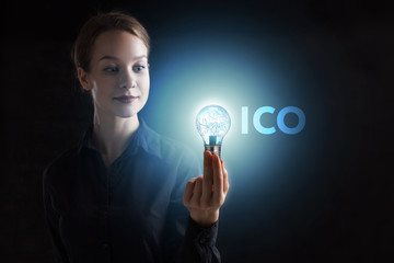 The concept of business, technology, the Internet and the network. A young entrepreneur working on a virtual screen of the future and sees the inscription: ICO