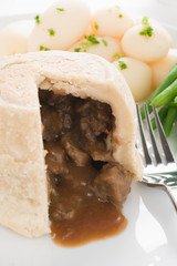 Wall Mural - Steak and kidney pudding a traditional steamed suet pastry pie