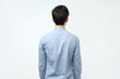 © Viktor Koldunov - Young man in blue shirt standing alone back side view