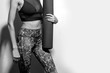 © Leart - Sporty and beautiful body of young  fit woman with yoga mat, black and white