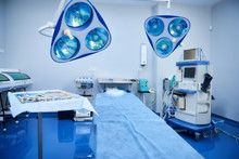 Sterile Operating Room With Table Of Instruments And Modern Equipment