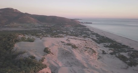Wall Mural - High aerial drone video orbiting left behind tall sand dune mountains view of Turkey's longest sand beach, ocean at sunset in Patara, Turkey. 4k at 23.97fps