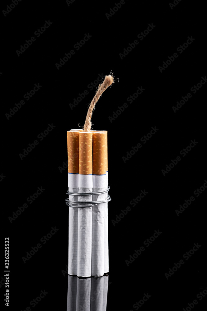 dynamite cigarette Several cigarettes bound, forming a package of with a lit fuse Stock Photo Trinkets & Trash